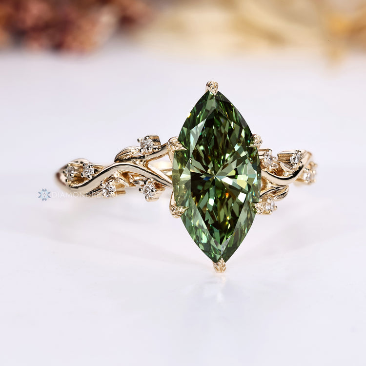 Green diamond ring with leaf style prong setting.