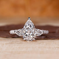 Cathedral diamond ring with pear cut centre stone.