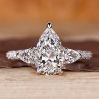 Cathedral diamond ring with pear cut centre stone.