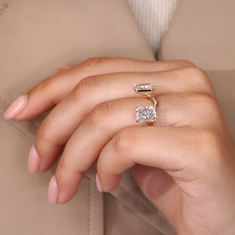 Handmade curved radiant diamond ring with claw prongs.