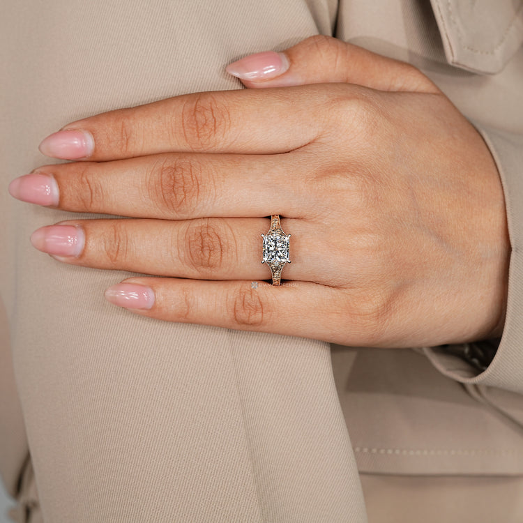 Princess cut diamond ring with vintage side stone design.