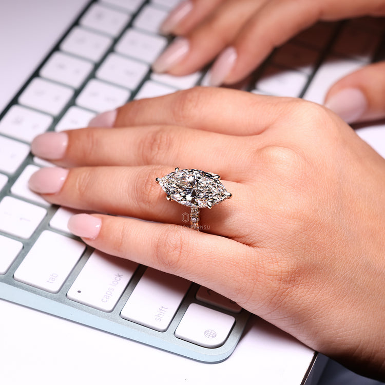Marquise diamond ring with round diamond hidden halo.