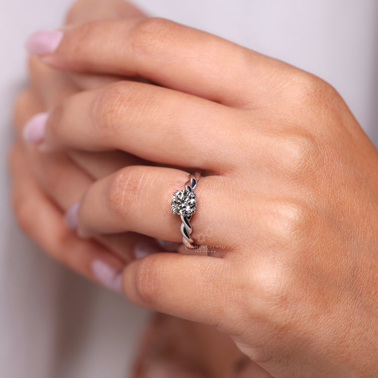 Twisted band round cut diamond engagement ring.