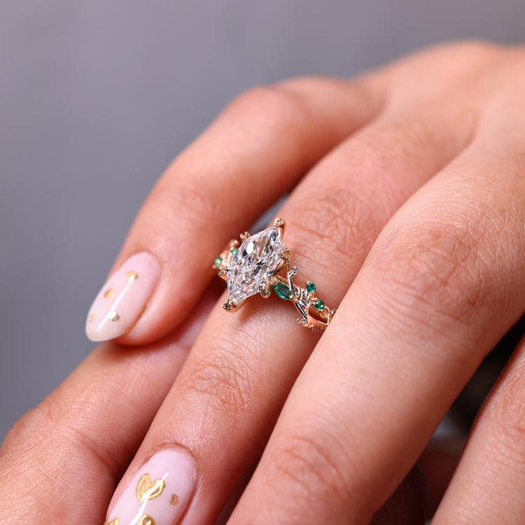 Buy Engagement ring with marquise and round side stone.