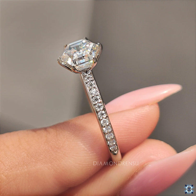 Hexagon engagement ring with round cut pave setting and white gold band.