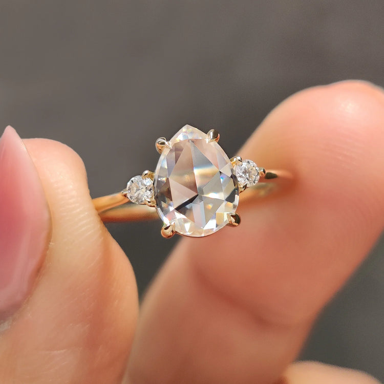 3 Stone Engagement Ring featuring a pear rose cut design and claw prong setting.