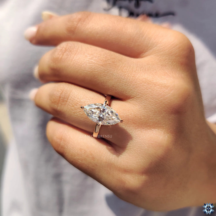 Marquise and round side stones create elegant sparkle and detail.