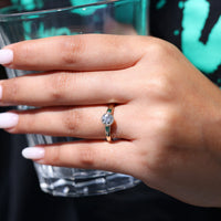 Side emerald diamond used in cathedral setting.