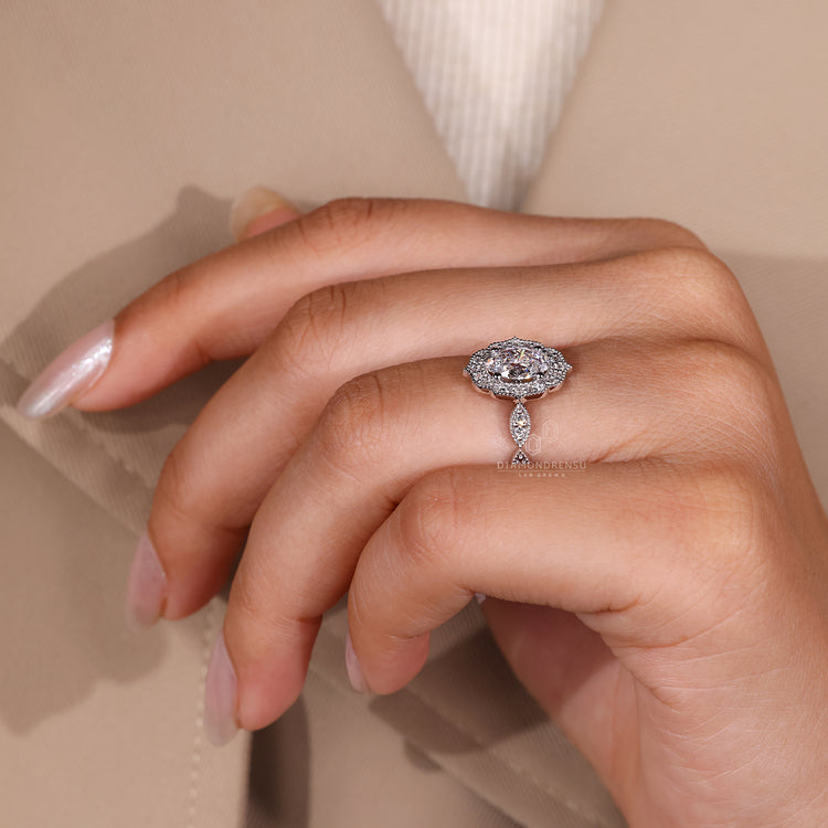 White Gold Ring featuring oval diamond and halo detail.