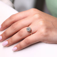 Round side stone in vintage engagement ring.