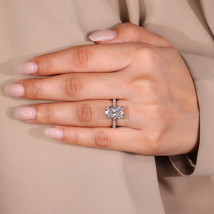 Round diamond pave band elongated cushion ring.