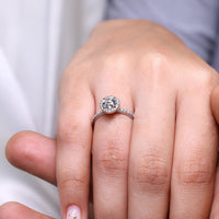 Round diamond pave ring with halo setting.