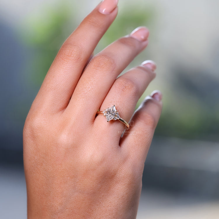 Handmade yellow gold solitaire ring with marquise diamond.