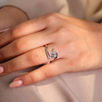 Rose gold ring with round side diamonds.