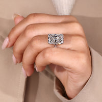 Custom diamond ring with radiant cut centre and pave band.