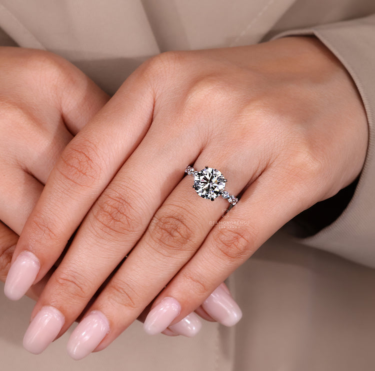 Three stone blue diamond ring with heart shape sides.