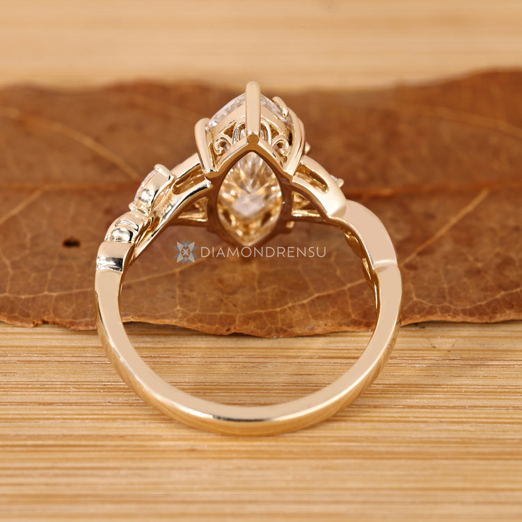 Marquise diamond ring with floral inspired details.