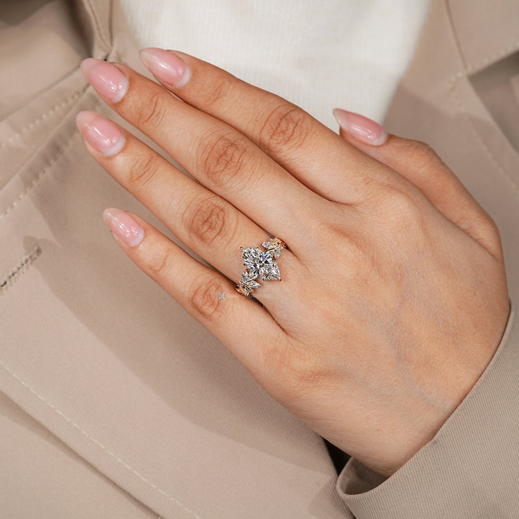 Marquise ring with round and marquise diamond clusters.