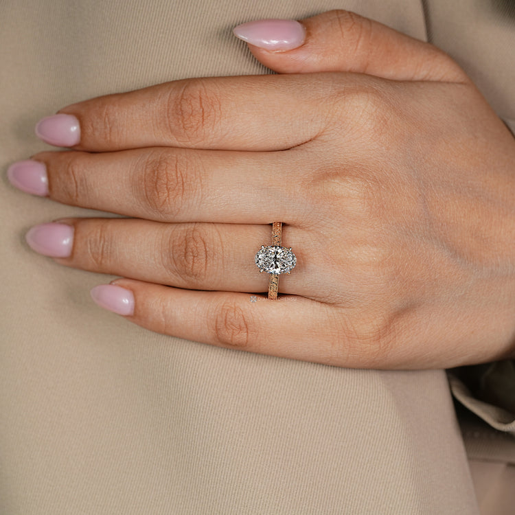 Oval diamond ring with four claw prong setting.
