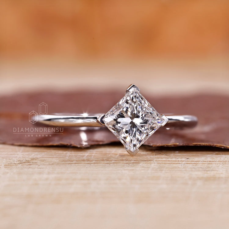 Solitaire engagement ring with compass prong setting.