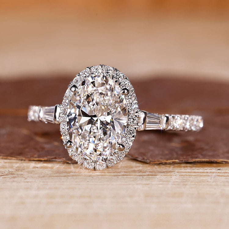 Oval shaped engagement ring with tapered baguette side stones.
