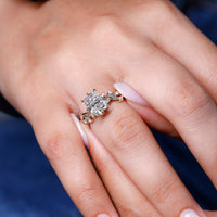 Yellow gold custom diamond ring with six-leaf prong design.
