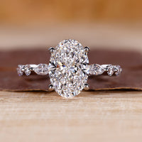 Oval diamond engagement ring with shared prong setting.