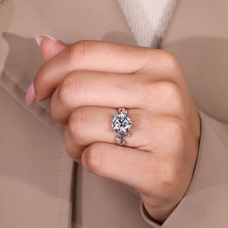 Round diamond ring with marquise side stones.