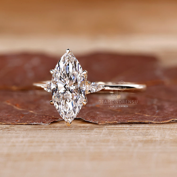 Lab grown marquise diamond ring three stone style.