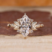 Marquise cut diamond ring with nature inspired design.