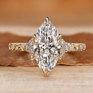 Marquise diamond ring with round side stones.