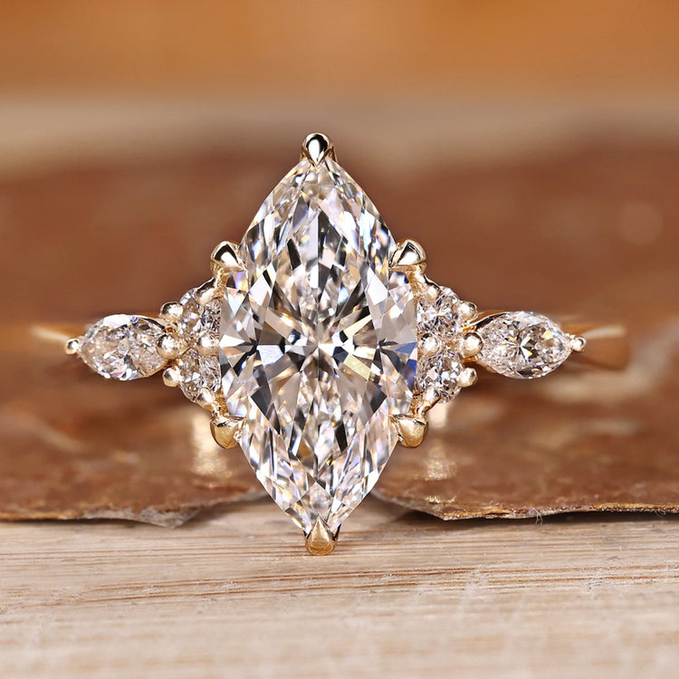 Marquise diamond ring with marquise and round side stones.