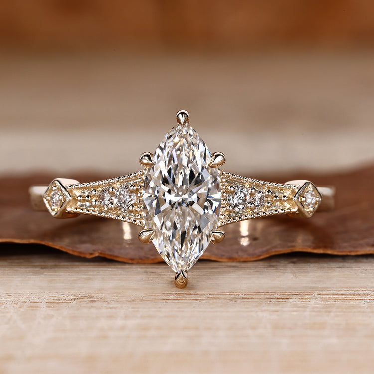 Marquise cut diamond ring vintage round side stones.