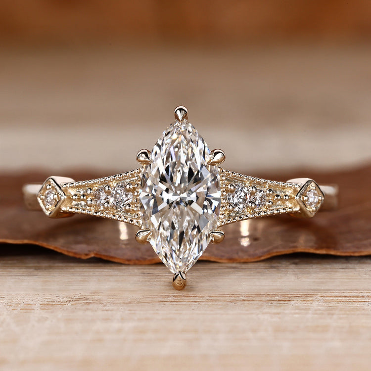 Marquise cut diamond ring vintage round side stones.