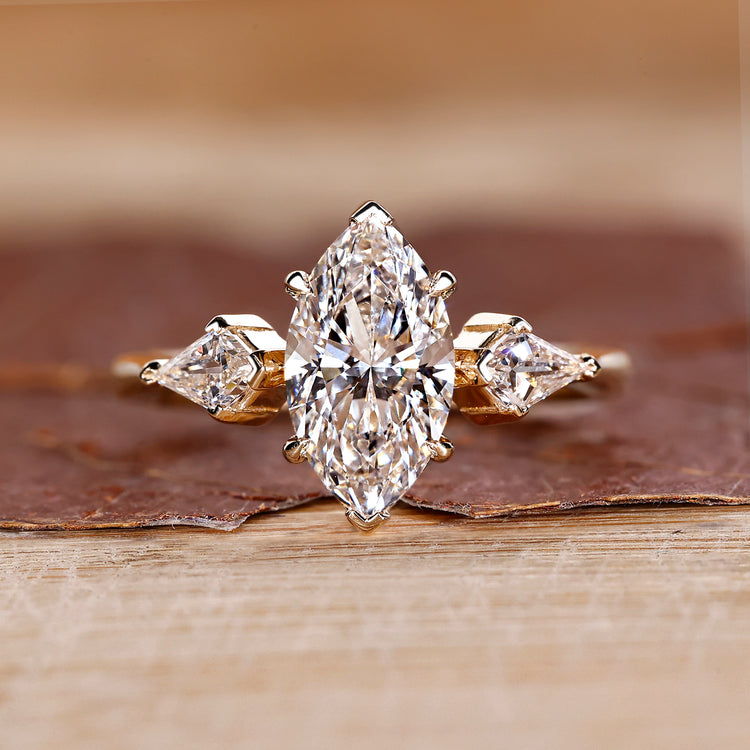 Three stone diamond ring with marquise centre stone.