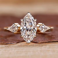 Three stone diamond ring with marquise centre stone.