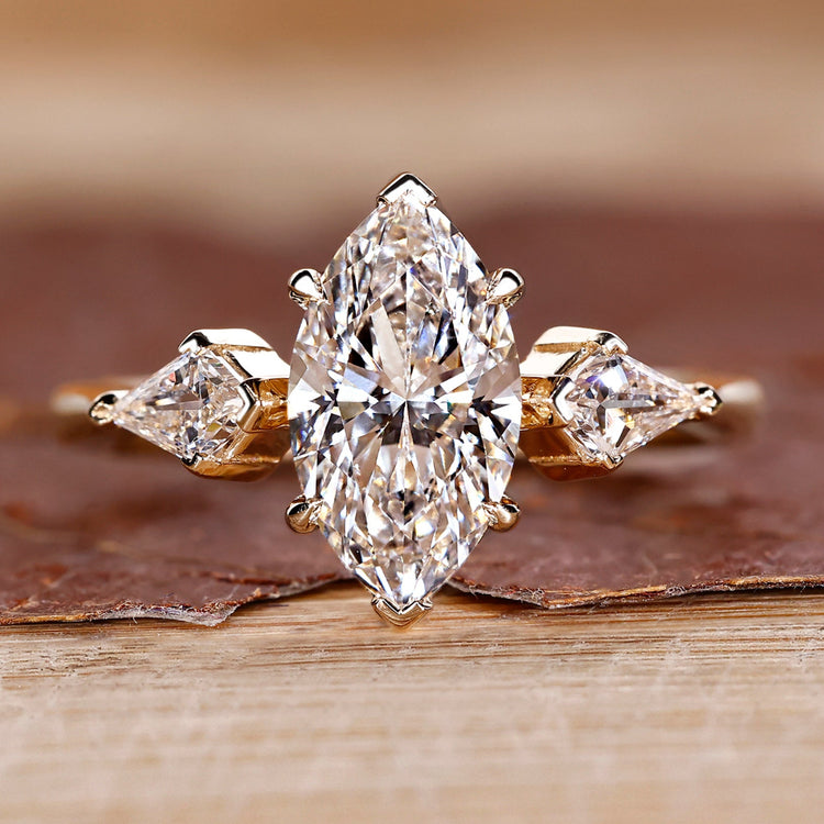 Three stone diamond ring with marquise centre stone.