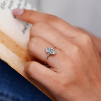 Marquise cut ring pear side stones tapered shank set.