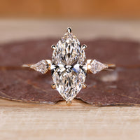 Marquise diamond engagement ring with hidden halo design.