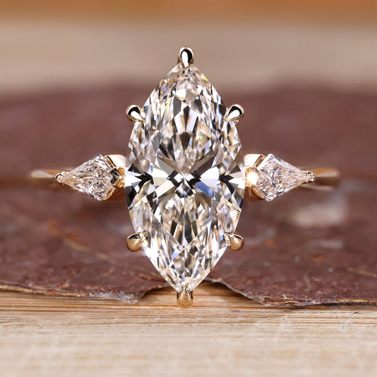 Marquise diamond engagement ring with hidden halo design.