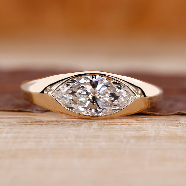 Flush diamond engagement ring with marquise diamond centre.