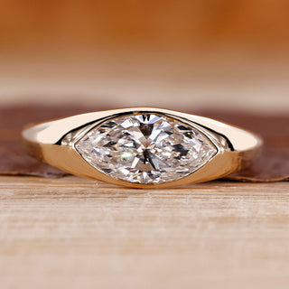 Flush diamond engagement ring with marquise diamond centre.