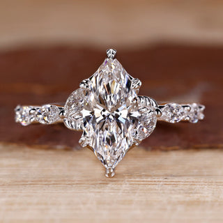 Nature inspired engagement ring with marquise cut diamond centre.