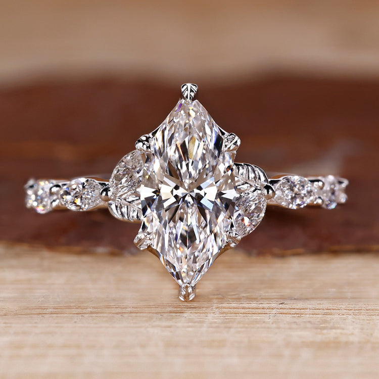 Nature inspired engagement ring with marquise cut diamond centre.