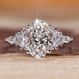 Oval diamond ring with marquise and round side stones.