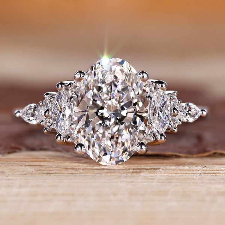 Oval diamond ring with marquise and round side stones.