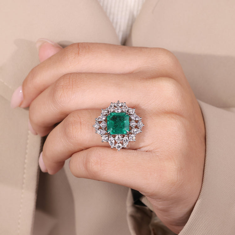 Emerald gemstone ring twisted shank cluster style.