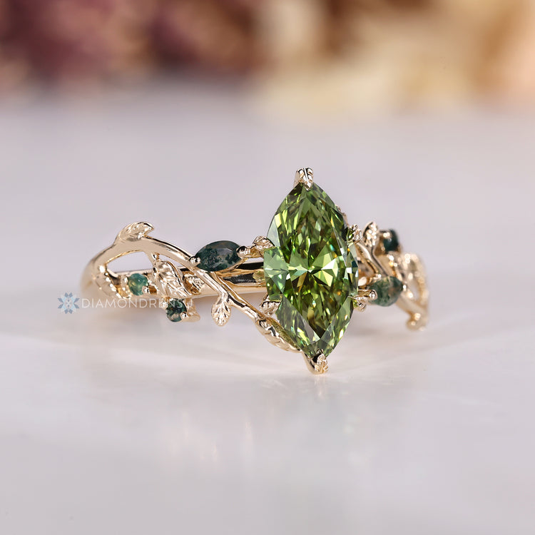 Green diamond ring with marquise moss agate side stones.