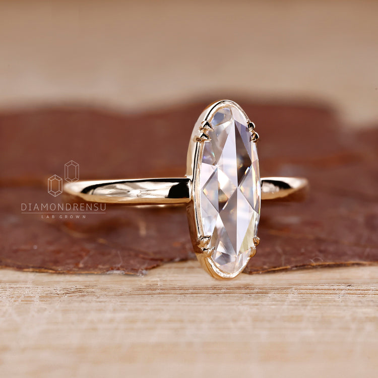 Solitaire moval rose diamond ring double claw prong.