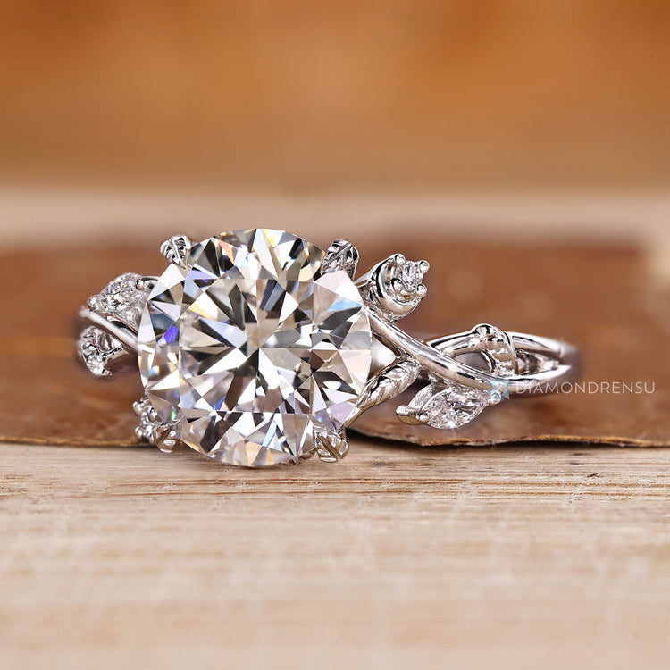 Round diamond ring with round side stone accents.